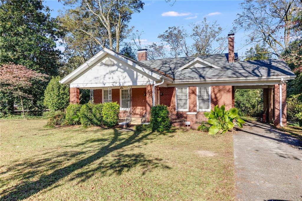 427 East College Street Bowdon, GA 30108 - Photo 3 of 30 a front view of a house with a garden and porch