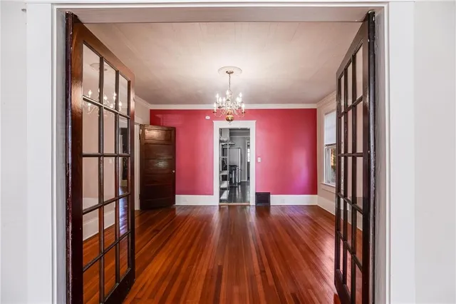 a view of a hallway with wooden floor and staircase