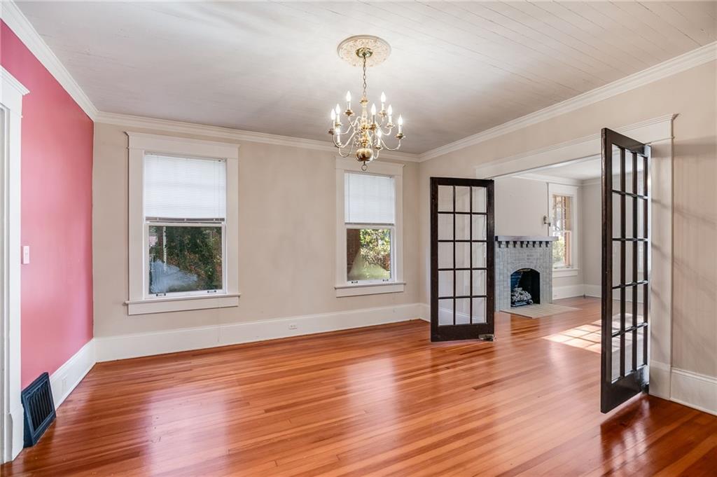 427 East College Street Bowdon, GA 30108 - Photo 10 of 30 a view of a livingroom with wooden floor and a chandelier