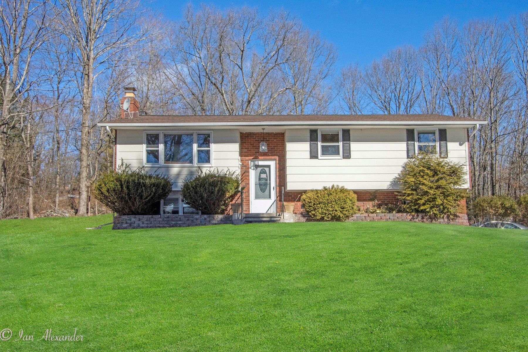 19 E Road Wallkill, NY 12589 - Photo 1 of 1 Bi-level home featuring a front yard and a chimney