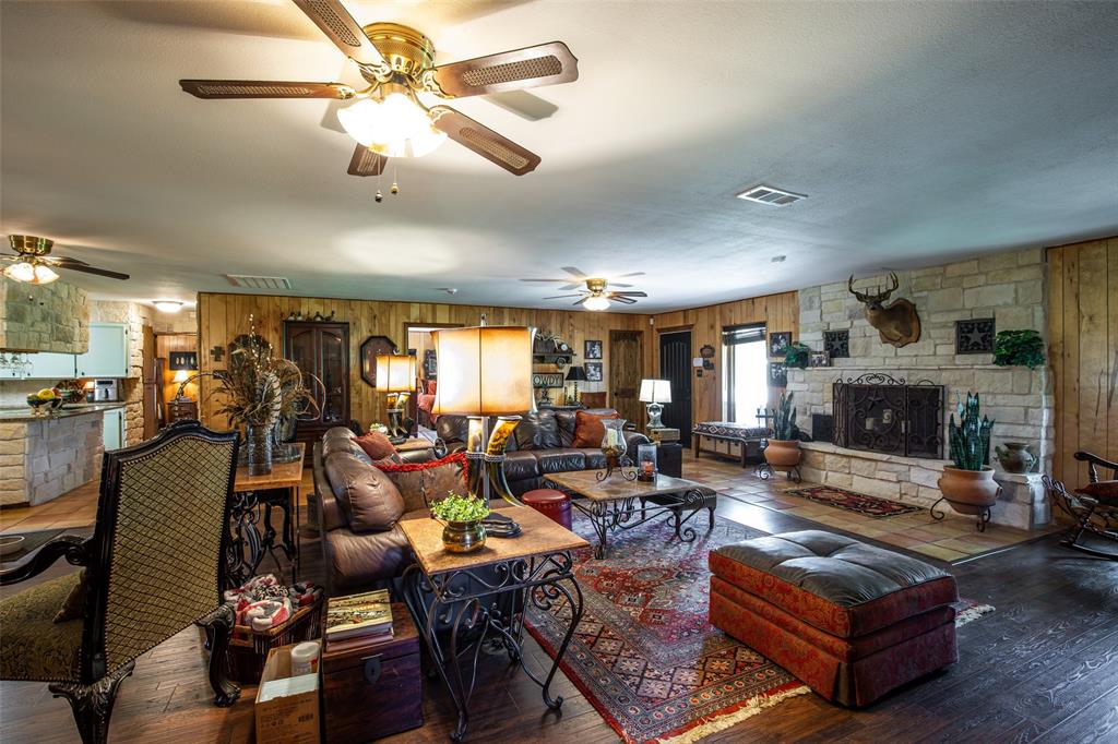 2043 Huddleston Road Sunset, TX 76270 - Photo 11 of 36 a living room with furniture fireplace and a chandelier