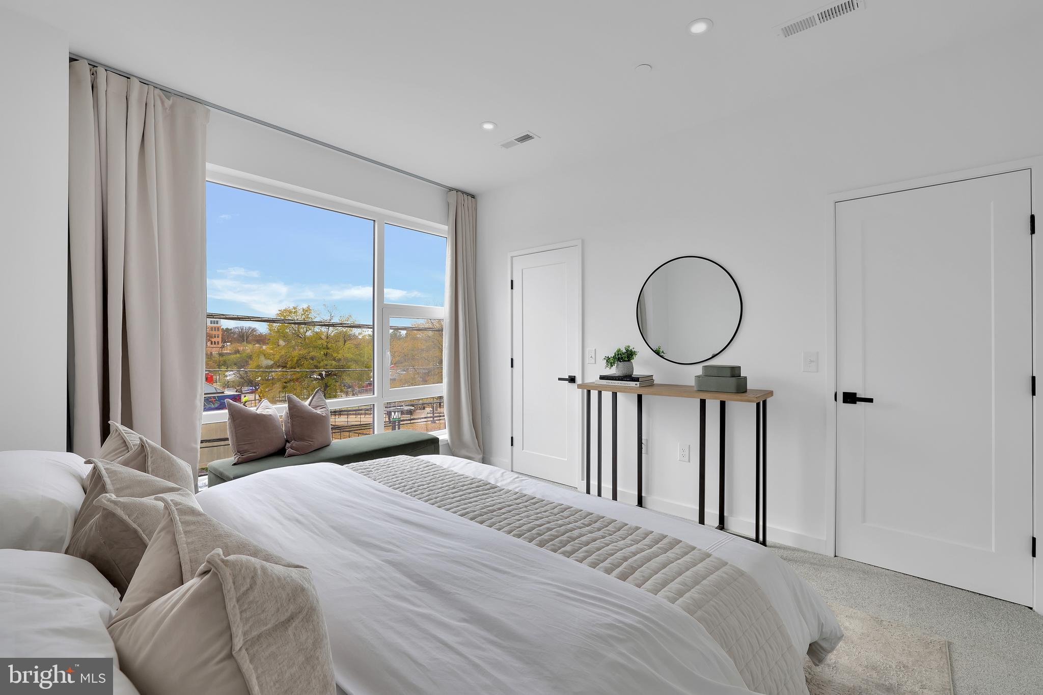 1028 Howard Road Southeast Washington, DC 20020 - Photo 12 of 35 a bedroom with a large bed and a large window