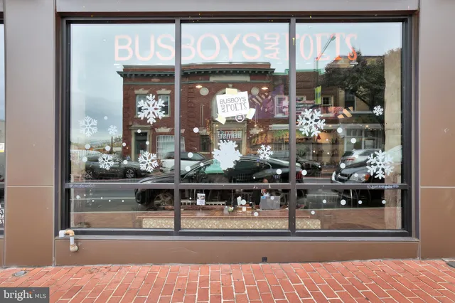 a view of a building on a street with a building and a people on a street