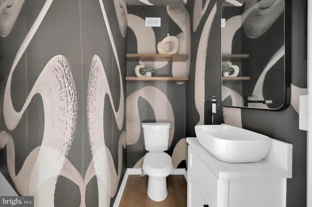 a bathroom with a toilet and a mirror