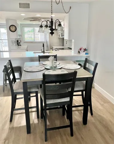 a dining room with a wooden table and chairs