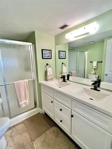 a bathroom with a double vanity sink and a mirror