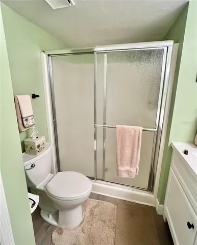 a white toilet sitting next to a shower