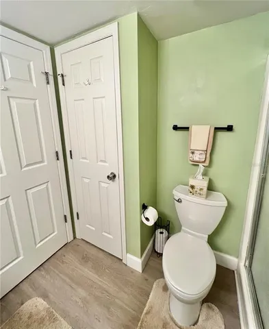 a bathroom with a toilet sink and a mirror