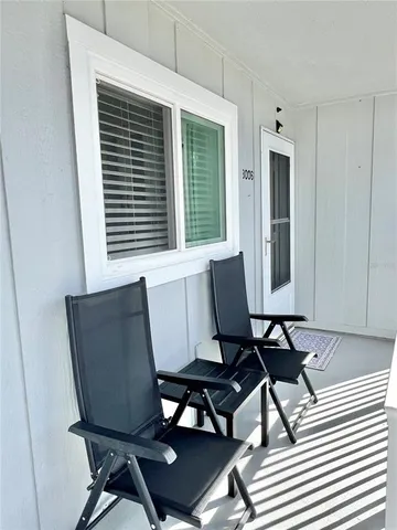 a view of a room with a table and chairs