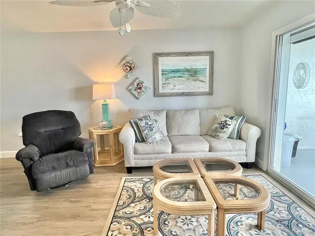 a living room with furniture a rug and a chandelier