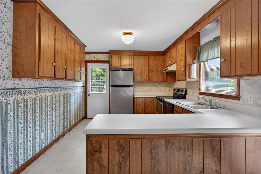 112 Holliday Lane Pendleton, SC 29670 - Photo 4 of 42 A well-appointed kitchen features ample wood cabinetry and white countertops, providing a functional cooking space.