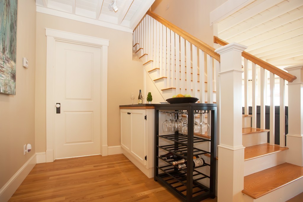 129 Fort Point Road Weymouth, MA 02191 - Photo 11 of 30 a view of a hallway with wooden floor and staircase
