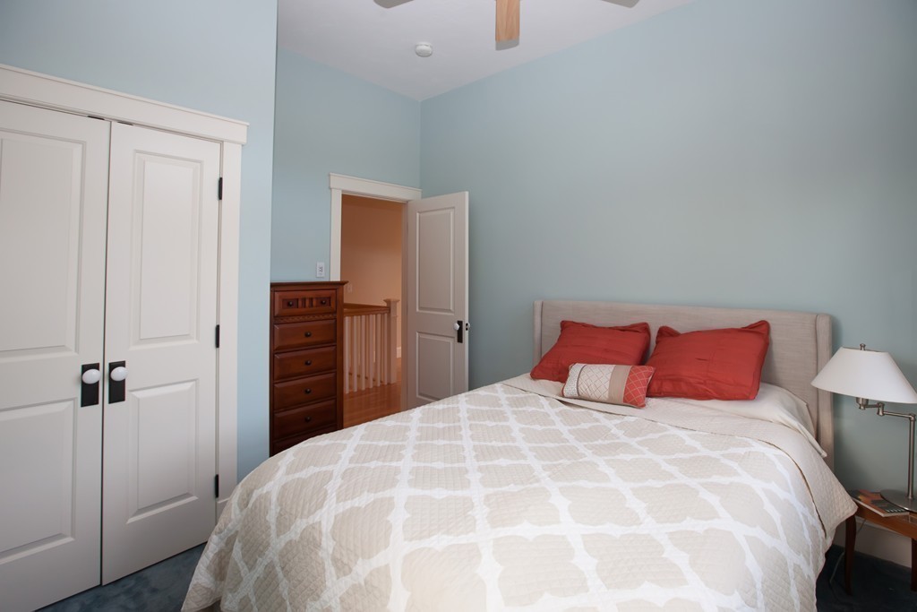 129 Fort Point Road Weymouth, MA 02191 - Photo 19 of 30 a large bed in a bedroom next to a cabinet