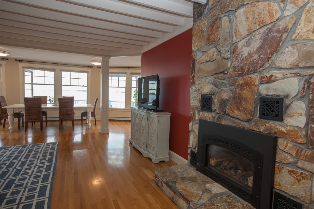 129 Fort Point Road Weymouth, MA 02191 - Photo 7 of 30 a living room with furniture wooden floor and a fireplace