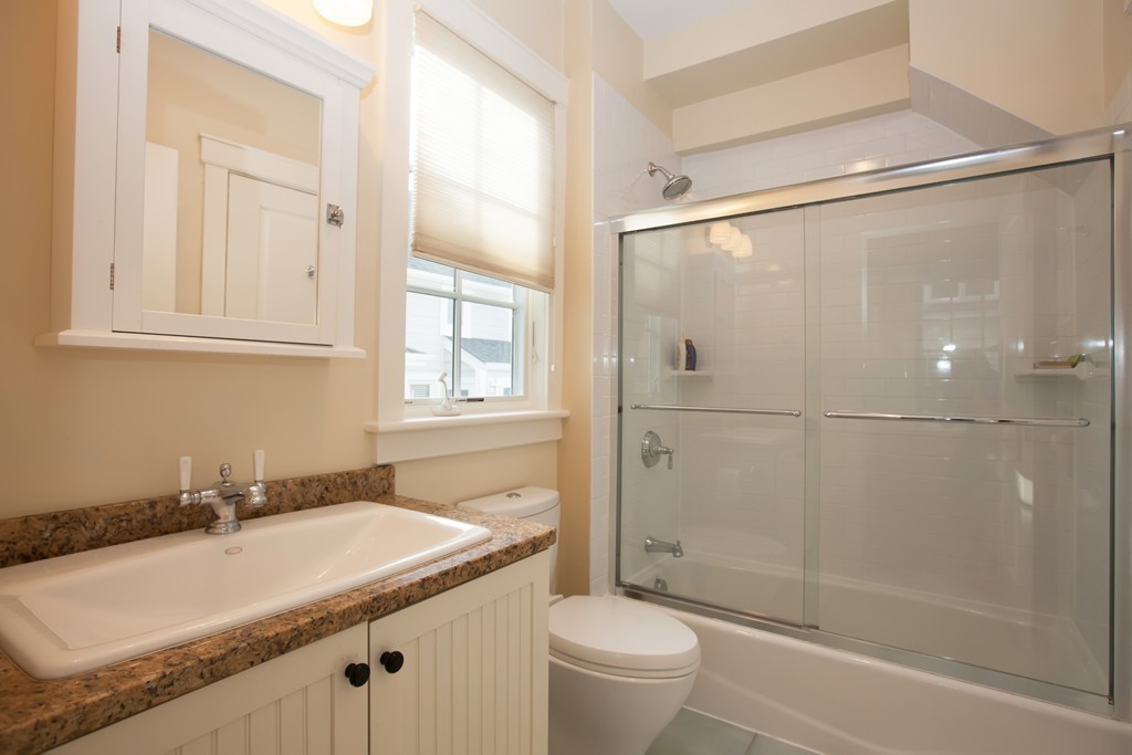 129 Fort Point Road Weymouth, MA 02191 - Photo 10 of 30 a bathroom with a granite countertop sink toilet and shower