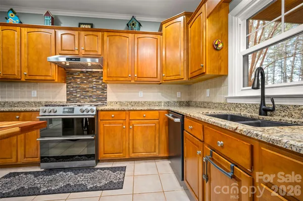 a kitchen with stainless steel appliances granite countertop a sink and cabinets
