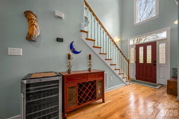a view of hallway with stairs and wooden floor