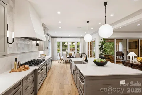 a kitchen with sink stove and living room view