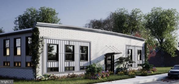 300 Penn Street, Unit 202 Pennsburg, PA 18073 - Photo 1 of 5 a view of a house with brick walls and flower plants