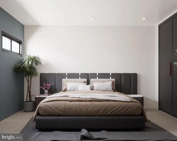 a bedroom with a large bed and a potted plant