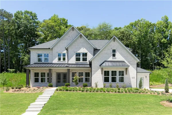 a front view of a house with a yard