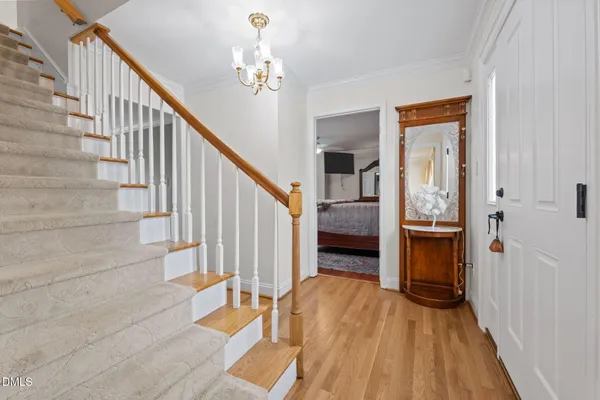 a large bedroom with a bed and wooden floor
