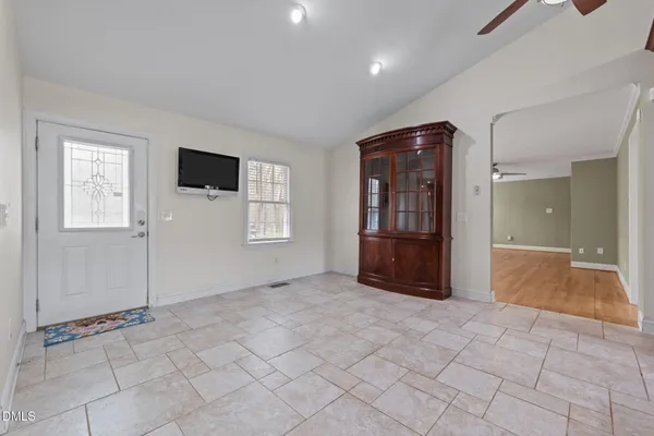 a view of a livingroom with wooden floor and a flat screen tv