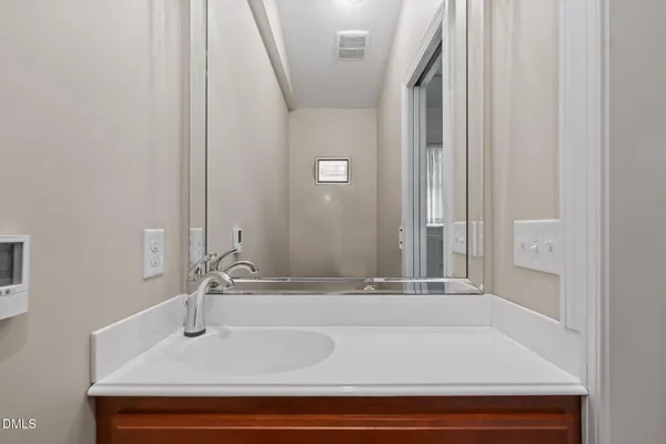 a bedroom with a bed and a flat tv screen on a dresser