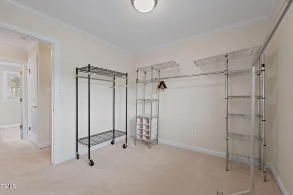 a bedroom with a bed and a flat tv screen on dresser