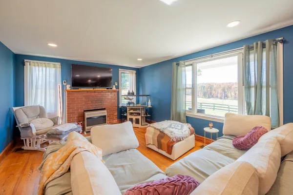 a living room with furniture a flat screen tv and a fireplace