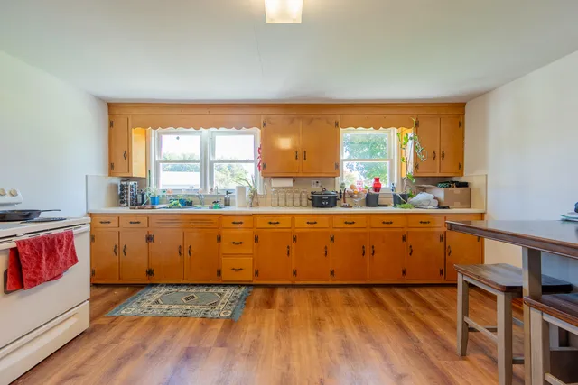 a room with a baby crib furniture and a window
