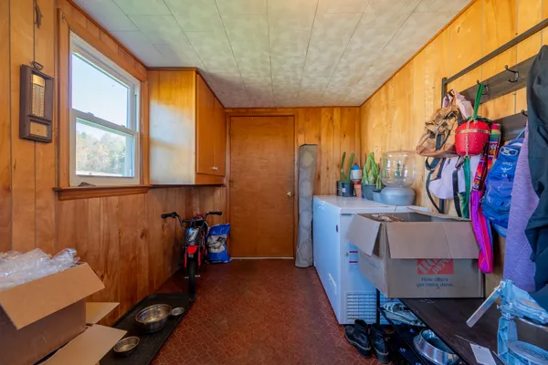 a bedroom with a bed a dresser and a painting on the wall
