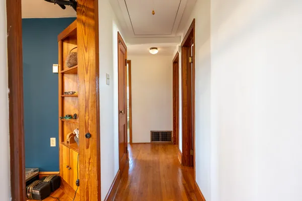 a bedroom with furniture and a wooden floor