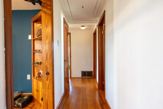 a bedroom with furniture and a wooden floor