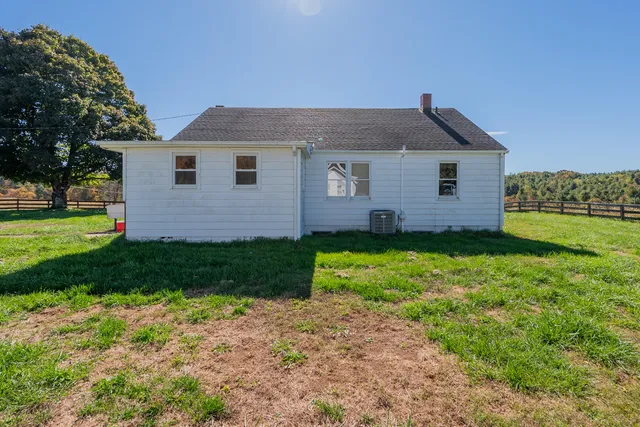 a view of a house with yard and tree s