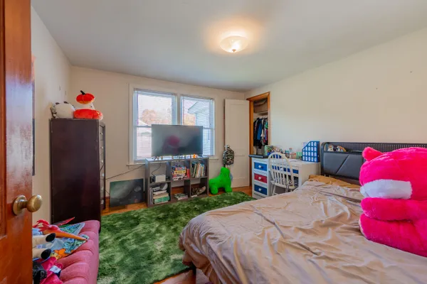 a bedroom with a bed a bookshelf and a closet