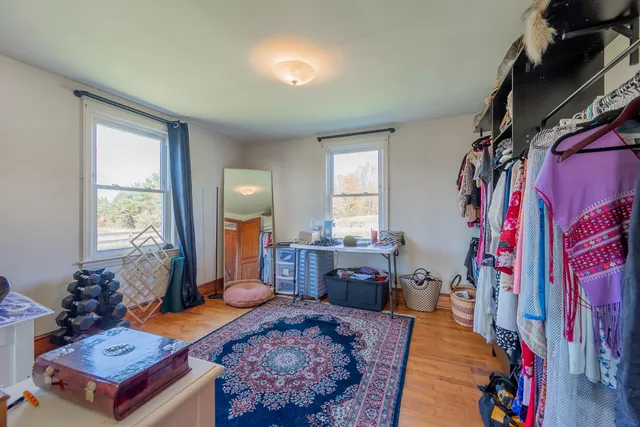 a bed sitting in a bedroom next to a window