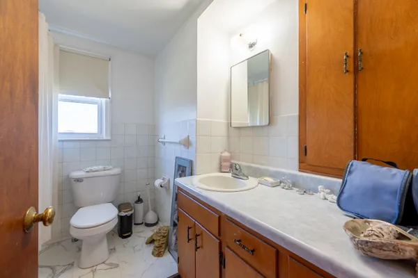 a view of a house with a yard and potted plants
