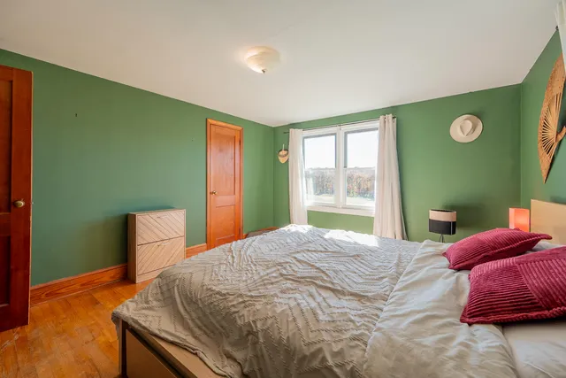 a house with green field in front of it