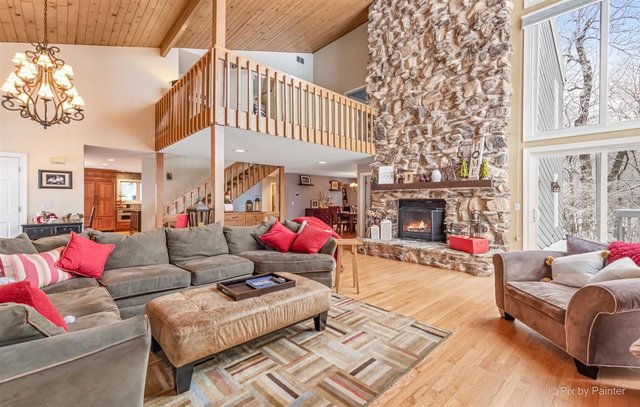 6914 Red Barn Road Crystal Lake, IL 60012 - Photo 19 of 63 a living room with furniture a fireplace and a large window