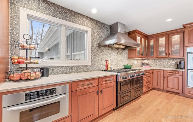 6914 Red Barn Road Crystal Lake, IL 60012 - Photo 28 of 63 a kitchen with stainless steel appliances granite countertop a stove and a sink