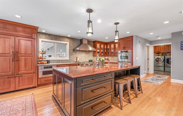 6914 Red Barn Road Crystal Lake, IL 60012 - Photo 29 of 63 a large kitchen with a table and chairs