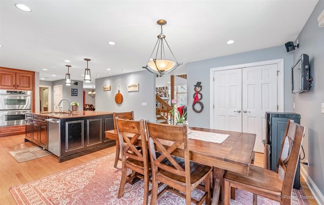 6914 Red Barn Road Crystal Lake, IL 60012 - Photo 31 of 63 a view of a dining room with furniture and a chandelier
