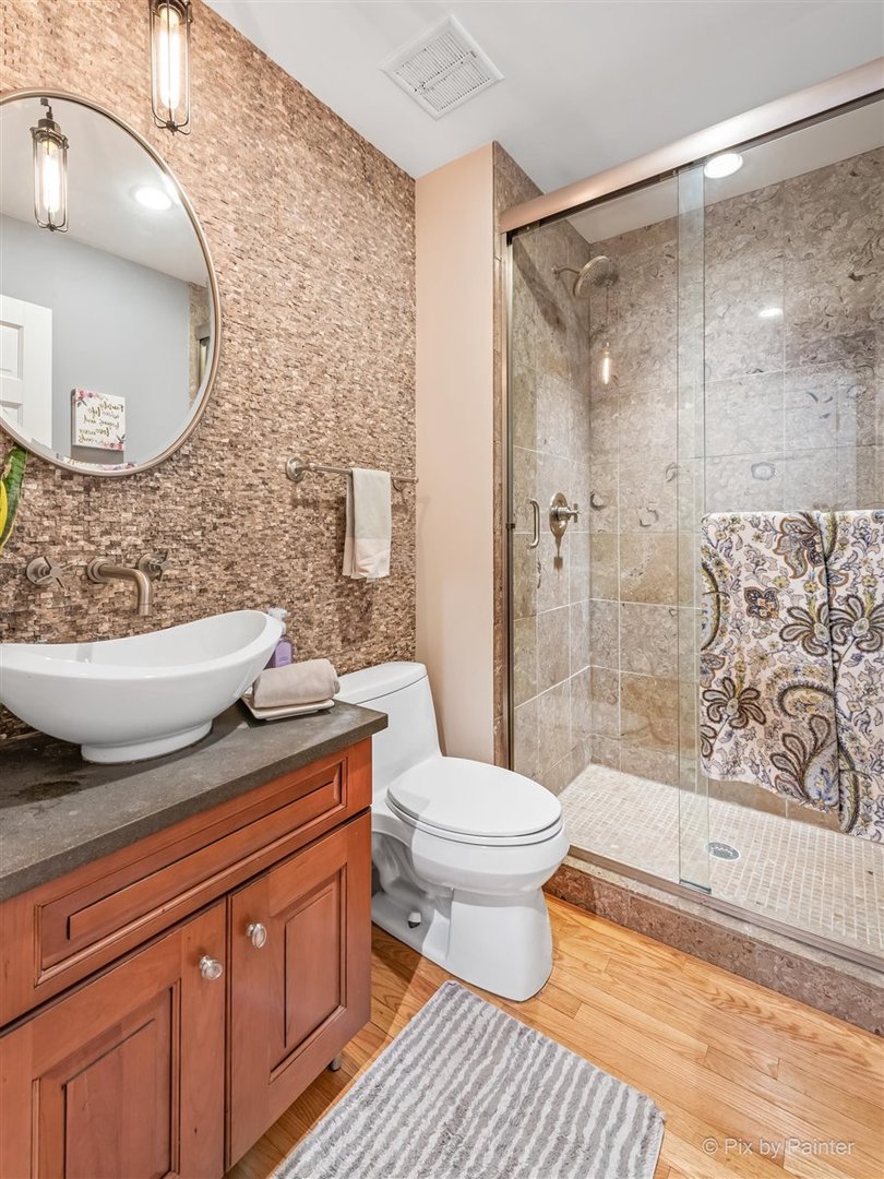6914 Red Barn Road Crystal Lake, IL 60012 - Photo 34 of 63 a bathroom with a granite countertop toilet a sink and a mirror