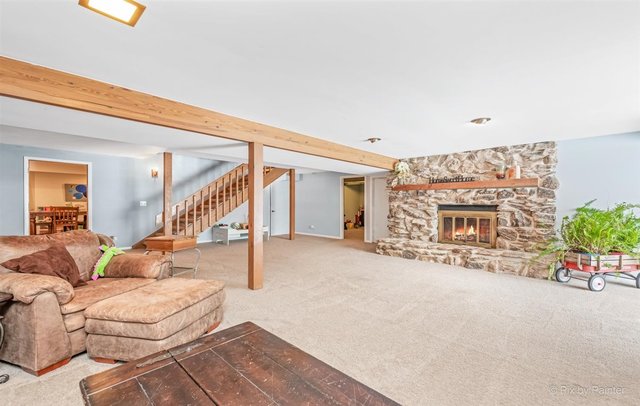 6914 Red Barn Road Crystal Lake, IL 60012 - Photo 37 of 63 a living room with furniture and a fireplace