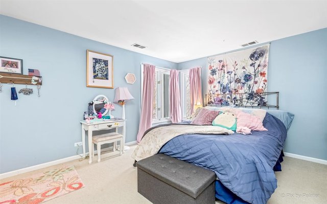 6914 Red Barn Road Crystal Lake, IL 60012 - Photo 49 of 63 a bedroom with a bed and a painting on the wall