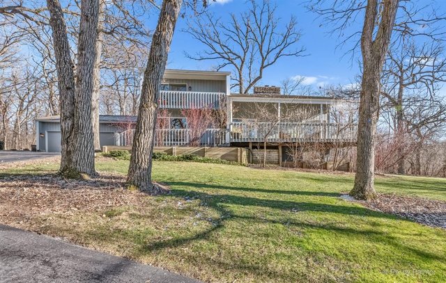 6914 Red Barn Road Crystal Lake, IL 60012 - Photo 54 of 63 a view of a house with a big yard and large trees