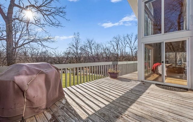 6914 Red Barn Road Crystal Lake, IL 60012 - Photo 60 of 63 a view of a balcony with two chairs and a table