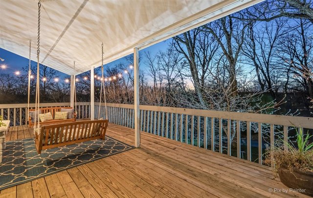 6914 Red Barn Road Crystal Lake, IL 60012 - Photo 10 of 63 a view of balcony with wooden floor and fence and a floor to ceiling window