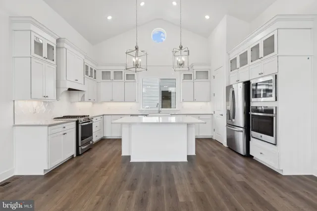 a kitchen with a white cabinets and stainless steel appliances